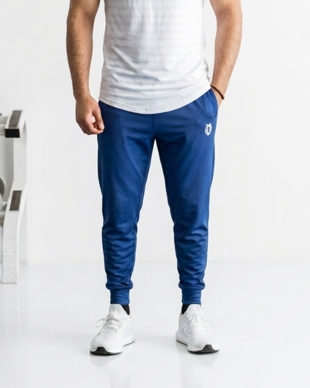 Men's blue joggers with elastic waistband and tapered fit.