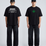 Black Goku Tee with green leaf design and text on back, casual streetwear style.