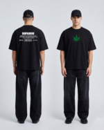 Black Goku Tee with green leaf design and text on back, casual streetwear style.